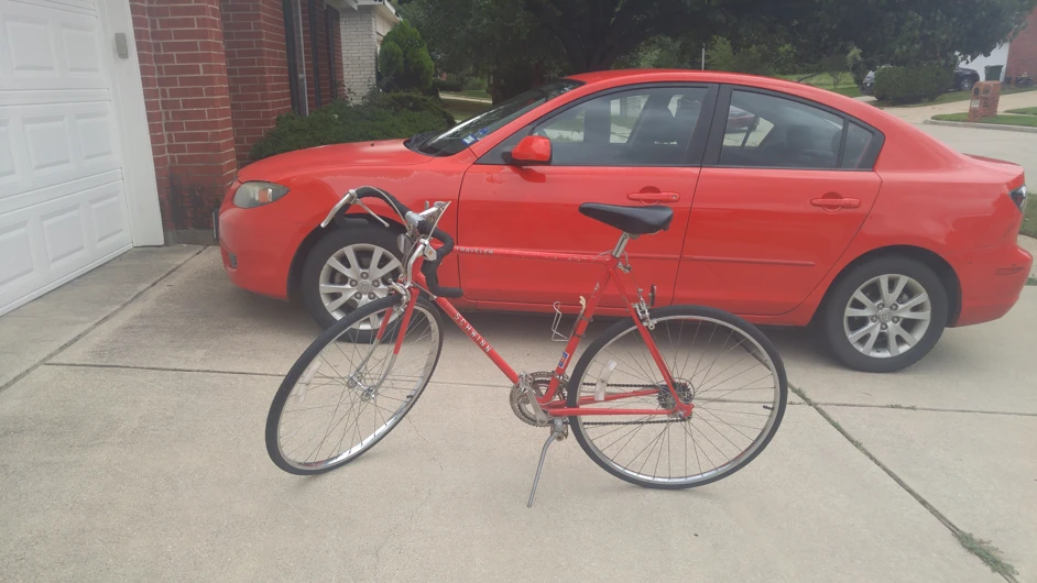 Bike after restoration, with my other red vehicle (car)